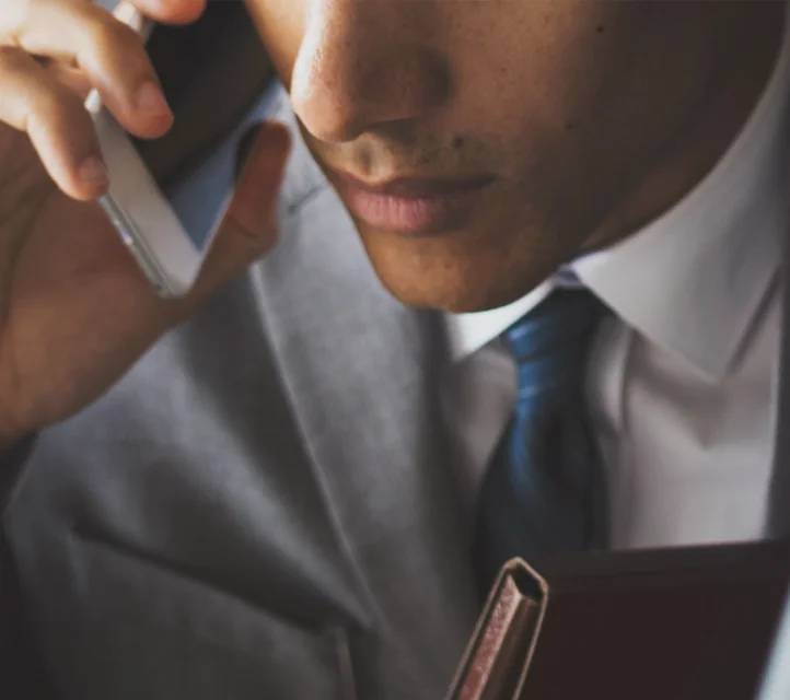 A mysterious man in business attire conducting a phone call.