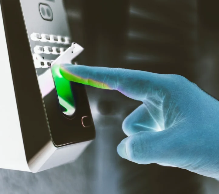 A finger pressing an important-looking biometric scanner.