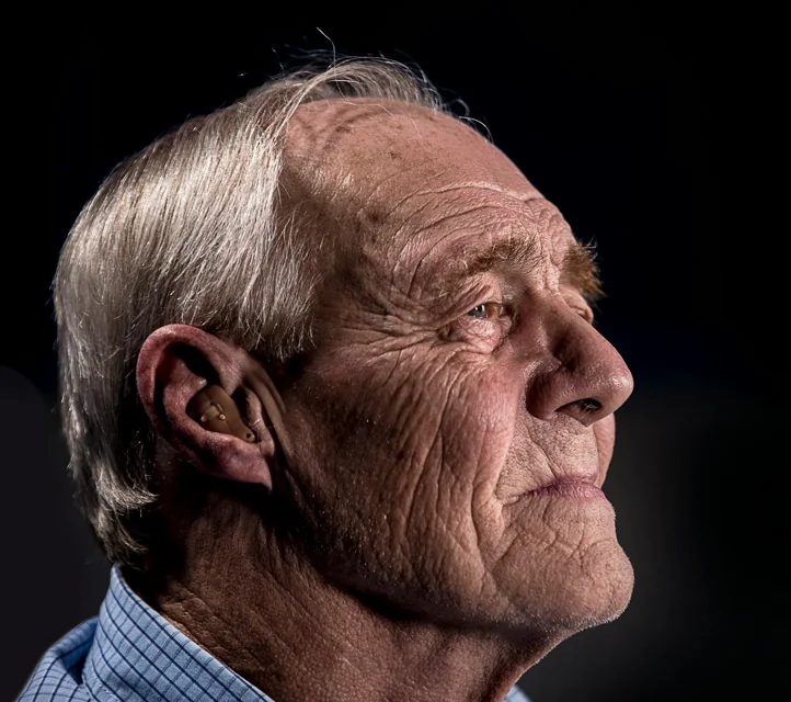An elderly man looking tired and sad.
